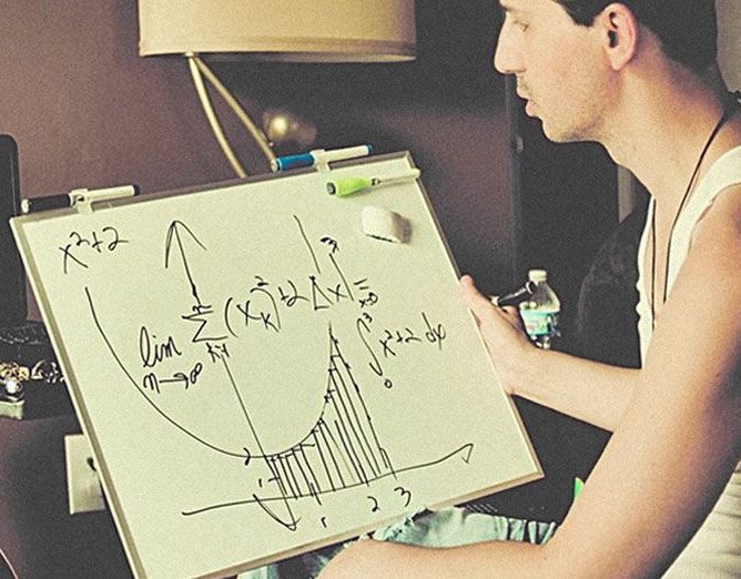 Man writing math formulas on the board